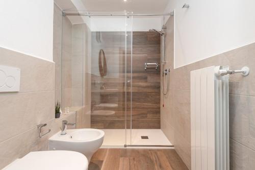 a bathroom with a shower and a toilet and a sink at Porto di Clanezzo in Clanezzo