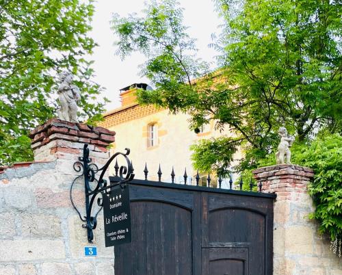 a gate to a house with a sign on it at Domaine La Reveille in Dore-lʼÉglise