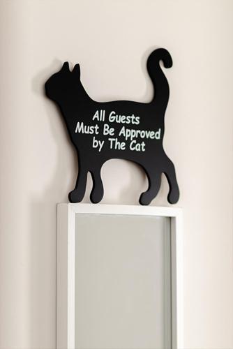 a black cat sign on top of a white shelf at Rooms AL-Zabut in Sambuca di Sicilia