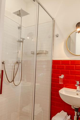a bathroom with a shower and a sink at Rooms AL-Zabut in Sambuca di Sicilia