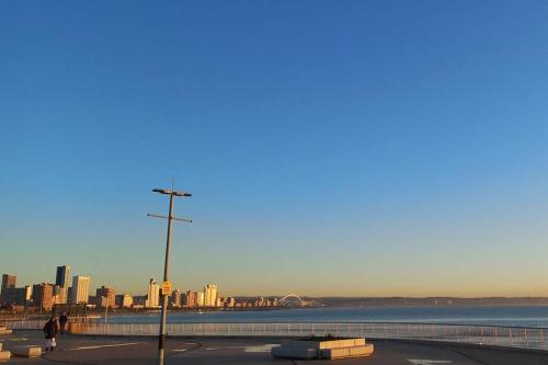 a view of a city with a street light and the ocean at Oceanic eleven in Durban