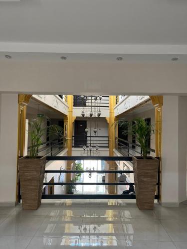 a lobby with two potted plants in a building at En Kaya Hotel in North Nicosia