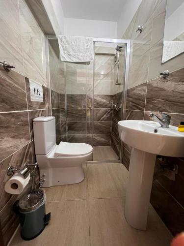 a bathroom with a toilet and a sink at En Kaya Hotel in North Nicosia