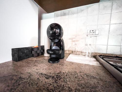 a black coffee maker sitting on a counter in a kitchen at 35-Casa Turrini Amiata, Aria condizionata, Val d'Orcia, Toscana, Sport, Natura in Castel del Piano