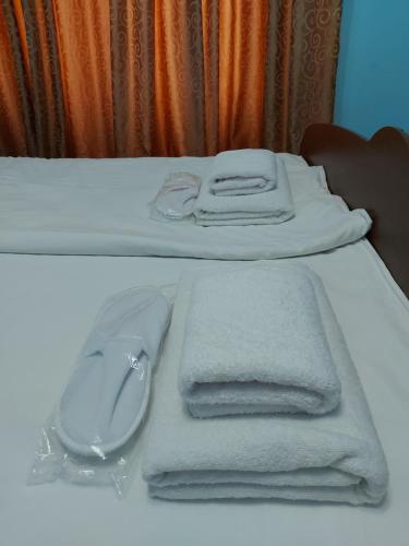 a bed with towels and a computer mouse on it at Апартаменты Denis in Gudauta