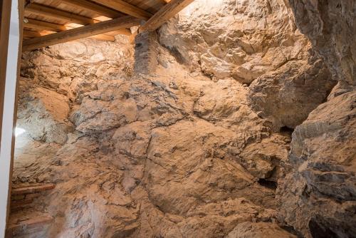 a rock wall in a room with a ceiling at Porto di Clanezzo in Clanezzo