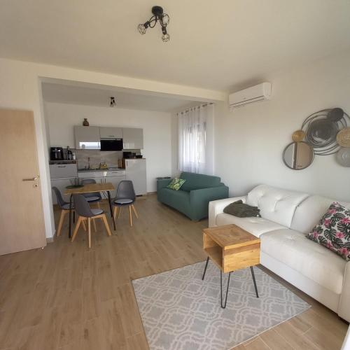 a living room with a couch and a table at Apartmani Tin in Starigrad-Paklenica