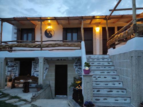 a house with a porch and stairs in front of it at Orange Garden Double Rooms in Kala Nera