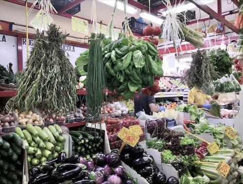 a produce section of a market with lots of vegetables at La Maison Boheme by Fra Cielo e Mare in Cagliari