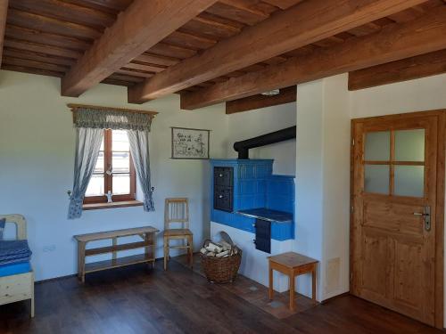 a room with a blue stove and a wooden door at Chaloupka Pomněnka na Lipce in Nasavrky