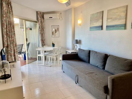 a living room with a couch and a table at Apartamentos Apal Chinasol in Almuñécar