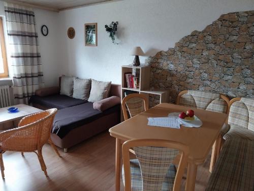 a living room with a couch and a table at Ferienwohnungen im Himmelreich in Lam