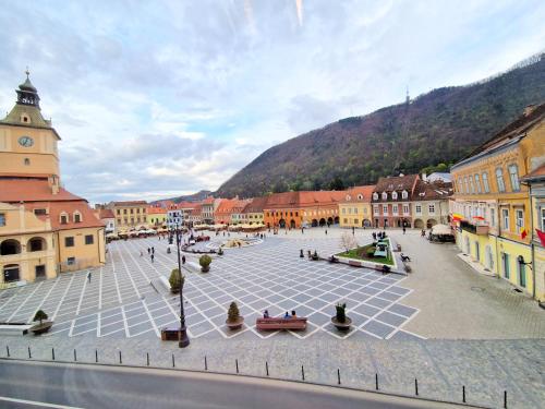 a town square with a clock tower and buildings at Key Apartments in Main Square in Braşov