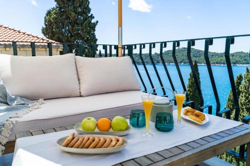 un vassoio di cibo su un tavolo sul balcone di Beach House Sveti Jakov 2 a Dubrovnik