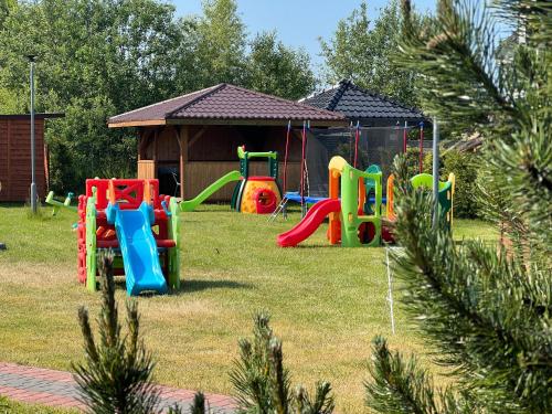 a playground in a yard with a house at Rajska Mierzeja in Sarbinowo