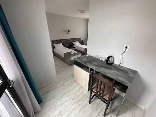 a room with a desk with a bed in the background at Studios and Apartments Pomorie in Pomorie