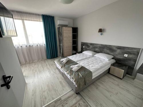 a bedroom with a large bed in a room at Studios and Apartments Pomorie in Pomorie