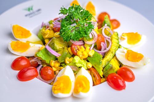 a salad with eggs and vegetables on a white plate at Poulo Wai Hotel & Apartment in Phnom Penh