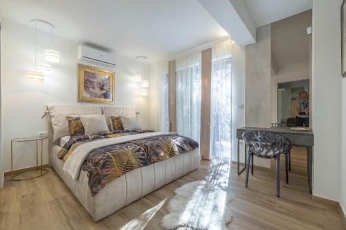 a bedroom with a bed and a desk and a table at Villa Hana Croatia in Mali Lošinj