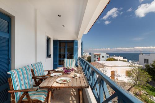 a table on a balcony with a view of the ocean at Nefeli's House in Souvala