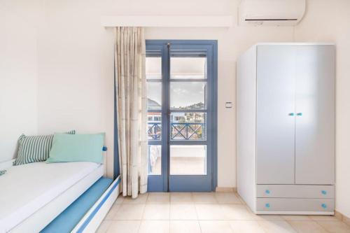 a bedroom with a bed and a sliding glass door at Nefeli's House in Souvala