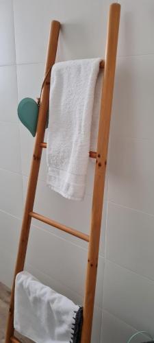 a towel rack in a bathroom with a white towel at הבית של כנרת in H̱efẕi Bah