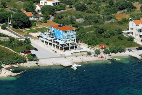 an aerial view of a beach with a blue building at Villa Mediterana in Seget Vranjica