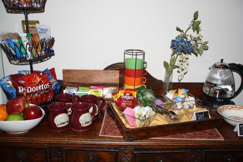a table with food and other items on it at Woodrow House Bed & Breakfast in Lubbock