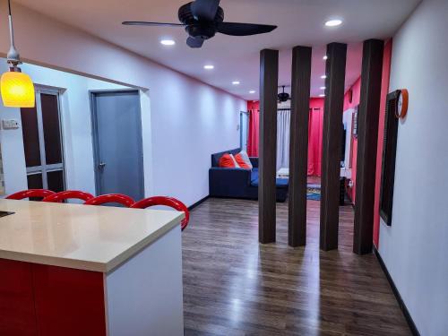 a room with red chairs and a room with a bed at 3 Bedrooms with Pool Hanan Residence Ketumbar Heights Condominium in Cheras