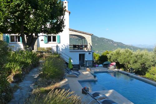 a swimming pool in front of a house at Provencal Villa with Stunning Views of the Sea and Mountains in Le Bar-sur-Loup