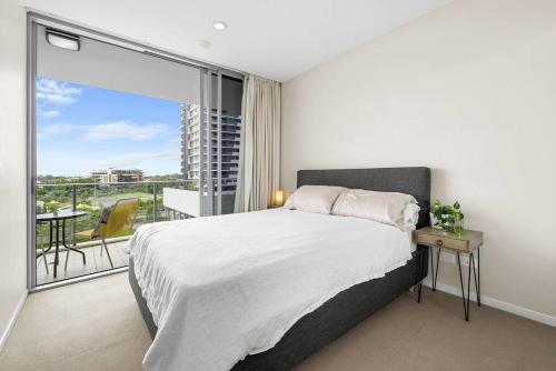 a bedroom with a bed and a large window at The Fijian Hospitality in Brisbane