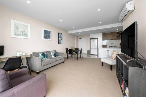 a living room with two couches and a dining room at The Fijian Hospitality in Brisbane