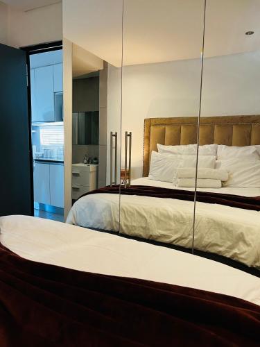 a bedroom with a large bed with a mirror at Urban Retreat with a View in Windhoek