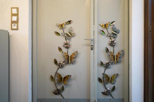 a bunch of butterflies on a wall at VENI Olive House in Kalamata