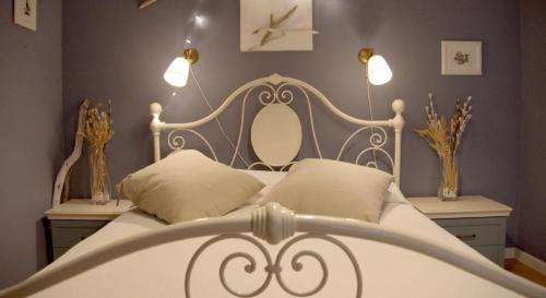 a bedroom with a white bed with two pillows at Casa Mirabella in Siracusa