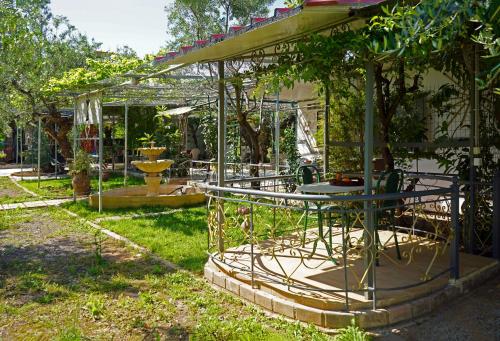a garden with a table and chairs in the yard at VENI Olive House in Kalamata
