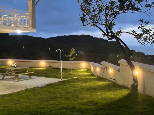 a park with a picnic table and a bridge at night at Villa Long View in Avliótai