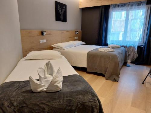 Postel nebo postele na pokoji v ubytování Hotel Mirtil