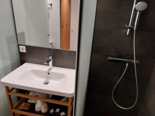 a bathroom with a sink and a shower at Hotel Mirtil in Pas de la Casa