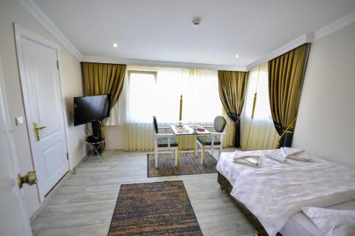 a hotel room with a bed and a table at LOCA Suit LİFE AİRPORT HOTEL in Istanbul