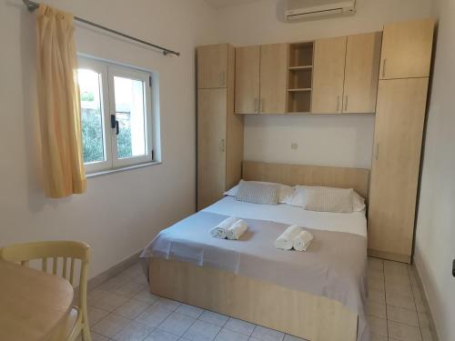 a bedroom with a bed with two towels on it at Vila Snježana Tučepi in Tučepi