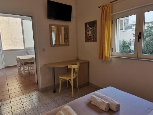 a room with a bed and a table and a desk at Vila Snježana Tučepi in Tučepi