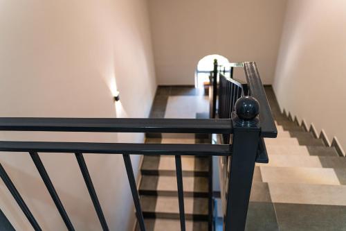 a stairway with a black railing and a stair case at BnB Hotel Shymkent in Shymkent
