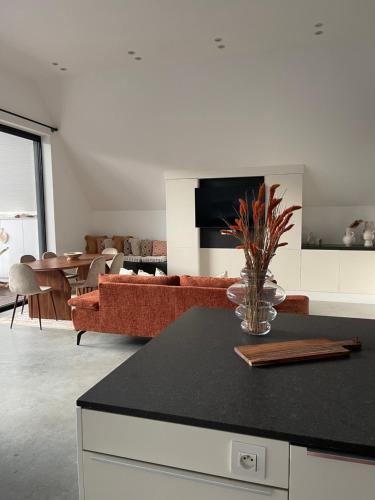 a living room with a couch and a table at KYMA - Luxurious & Peacefull Apartment in Brussels