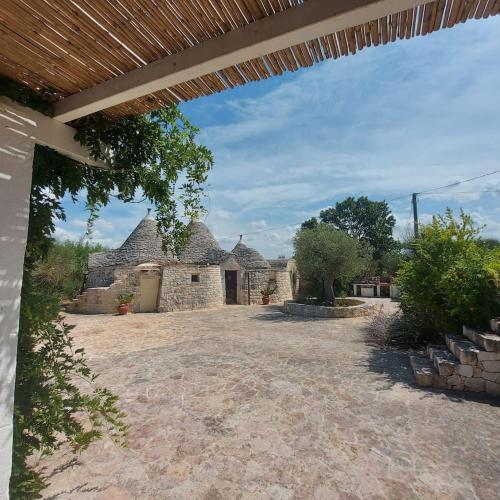 an outside view of a house with a patio at Trullo Raimondo in Martina Franca