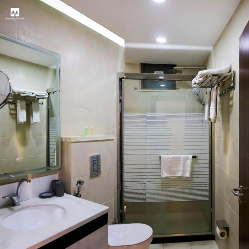 a bathroom with a shower and a sink and a toilet at Jordan Seasons Hotel in Aqaba