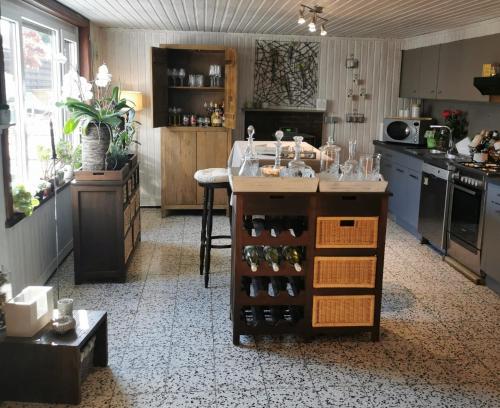 a kitchen with a island with wine bottles at La Constance 