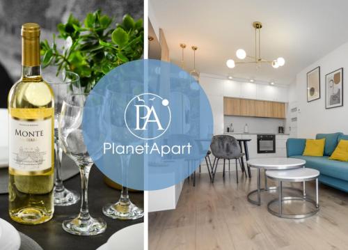 a kitchen and a living room with a bottle of wine and a wine glass at PlanetAparts in Darłowo