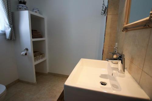 a bathroom with a white sink and a toilet at LA VILLA DU PETIT BOIS Les Lavandes in Faucon
