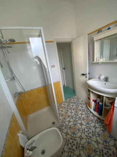 a bathroom with a shower and a toilet and a sink at Casa Franco in Ischia Town
